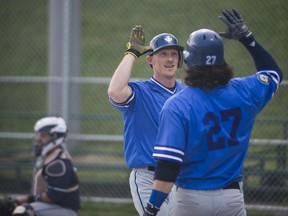 Maple Leafs designated hitter Marcus Knecht crosses home plate and congratulates teammate Grant Takamatsu during IBL action against the Barrie Baycats on Wednesday, June 6, 2018, in Toronto. (ERIN RILEY/PHOTO)