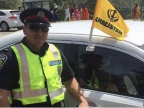 A photo of a smiling Peel Regional Police officer standing next to a cruiser that was flying a Khalistani flag recently surfaced on social media.