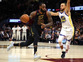 LeBron James of the Cleveland Cavaliers drives to the basket defended by Stephen Curry of the Golden State Warriors in the second half during Game Three of the 2018 NBA Finals at Quicken Loans Arena on June 6, 2018 in Cleveland, Ohio.