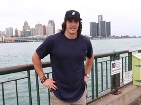 Detroit Lions tight end Luke Willson of LaSalle, Ont., poses for a photo at riverfront Caron Avenue Pumping Station Park in Windsor. In the background is Detroit's riverfront skyline. (JOHN KRYK/Postmedia Network)