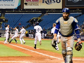 Matt Duffy of the Tampa Bay Rays celebrates with teammates after hitting a walk-off single against the Toronto Blue Jays on June 13, 2018 at Tropicana Field