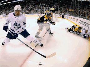 In this photo shot with a fisheye lens, Toronto Maple Leafs' Auston Matthews (34) keeps the puck from Boston Bruins' Rick Nash (61) during the first period of Game 2 of an NHL hockey first-round playoff series in Boston, Saturday, April 14, 2018.