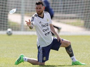 Lionel Messi throws a bottle of water during a training session in Russia on Friday. AP PHOTO
