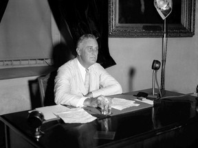 FILE - This July 24, 1933 file photo shows President Franklin D. Roosevelt appealing to the nation via radio for immediate enrollment of all employers under the blanket agreement to raise wages and create jobs, in Washington.  (AP Photo, File)