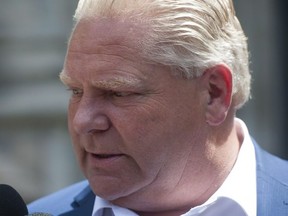 Ontario Premier-designate Doug Ford speaks to reporters before heading into Whitney Block for a meeting with his transition team in Toronto, Sunday, June 10, 2018. Ford says his first act as Ontario premier will be to scrap the province's cap-and-trade system and challenge federal rules on carbon pricing.