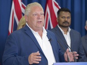 Ontario PC Leader Doug Ford speaks as candidate Roshan Nallaratnam (right) looks on during a campaign announcement in Toronto on Monday, June 4, 2018. THE CANADIAN PRESS/Frank Gunn