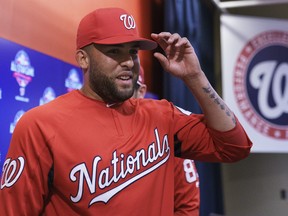 Newly acquired pitcher Kelvin Herrera walks from a new conference after speaking to the media before a game against the Baltimore Orioles, Tuesday, June 19, 2018, in Washington. (AP Photo/Carolyn Kaster)
