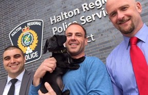 From left: Halton Regional Police Det.-Const. Stephane Berreault. owner Matthew Granger with Tank and Det.-Const. Lee Wood (Joe Warmington, Toronto Sun)