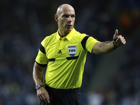 In this Tuesday, Oct. 1, 2013 file photo, referee Howard Webb gestures during the Champions League group G soccer match between FC Porto and Atletico de Madrid in Porto, northern Portugal. (AP)