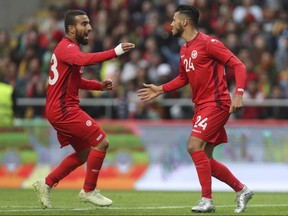Tunisia's Anice Badri, right, celebrates with Naim Sliti after scoring his side's first goal during a friendly soccer match between Portugal and Tunisia in Braga, Portugal, Monday, May 28, 2018. (AP Photo/Luis Vieira)