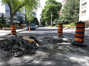A selection of bad roads for cyclists are not always main routes as you look northbound up one-way Walmer Rd. just west of Spadina Ave. and St. Clair Ave. W. in midtown Toronto on Tuesday June 19, 2018. (Jack Boland/Toronto Sun/Postmedia Network)