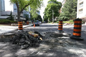 A selection of bad roads for cyclists are not always main routes as you look northbound up one-way Walmer Rd. just west of Spadina Ave. and St. Clair Ave. W. in midtown Toronto on Tuesday June 19, 2018. (Jack Boland/Toronto Sun/Postmedia Network)