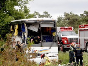 Police and firefighters respond to a serious collision involving a passenger bus west of Prescott on Highway 401 on Monday, June 4, 2018.(MARSHALL HEALEY/Special to Postmedia)