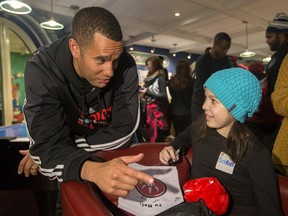 Raptor assistant coach Jama Mahlalela visits with Melissa Vella,11 during the Raptors visit to Sick Kids Hospital in Toronto on Tuesday January 13, 2015. Dave Abel/Toronto Sun/QMI Agency Mahlalela is the new head coach of Raptors 905.