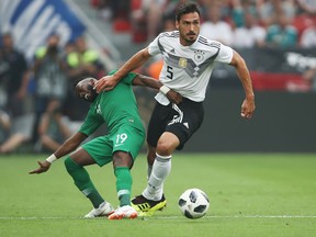 Mats Hummels of Germany eludes Fahad-Al-Muwallad of Saudi Arabia during an international friendly match ahead of the FIFA World Cup at BayArena on June 8, 2018
