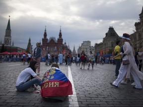 Russian fans sit in Moscows Red Square during the World Cup. AP PHOTO