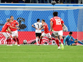 Russia's midfielder Denis Cheryshev (C) scores during the Russia 2018 World Cup Group A football match between Russia and Egypt at the Saint Petersburg Stadium in Saint Petersburg on June 19, 2018. GIUSEPPE CACACE/AFP/Getty Images