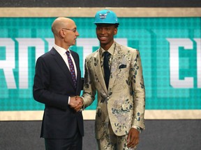 Shai Gilgeous-Alexander poses with NBA Commissioner Adam Silver after being drafted eleventh overall by the Charlotte Hornets during the NBA Draft at the Barclays Center on June 21, 2018 in Brooklyn. He was later flipped to the Clippers. (GETTY IMAGES)