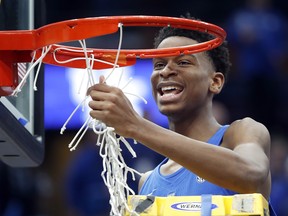 Kentucky guard Shai Gilgeous-Alexander cuts down the net after Kentucky defeated Tennessee 77-72 in  the final of the Southeastern Conference men's basketball tournament  on March 11, 2018, in St. Louis. (JEFF/ROBERSON/AP)