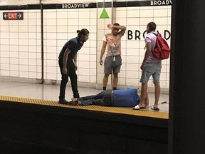 Three men look on after rescuing a blind man that had fallen onto the subway tracks at Broadview Station in Toronto on Thursday, June 28, 2018. A Toronto transit rider credited with saving a man who fell onto the subway tracks said he couldn't have done it without the help of two others who jumped in with him.