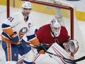 New York Islanders captain John Tavares (91) moves in on Montreal Canadiens goaltender Antti Niemi in Montreal, Wednesday, February 28, 2018. (THE CANADIAN PRESS/Graham Hughes)