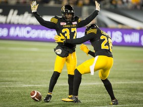 Hamilton Tiger-Cats defensive back Richard Leonard is "searched" by teammate Hamilton Tiger-Cats defensive back Craig Butler after making an interception against the Montreal Alouettes on Nov. 3, 2017