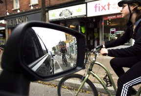 Cyclists ride on the designated Bloor Street bike lanes in Toronto. (Nathan Denette/The Canadian Press)