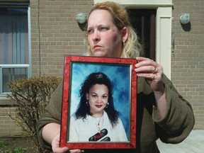 In this 2002 Sun file photo, Tracy Christie holds a photo of her daughter Christie Christie, who was killed in a home invasion in Scarborough in 1996. (Ernest Doroszuk/Toronto Sun/Postmedia Network)