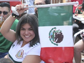 Mexican fans at the El Rincon Mexicano restaurant on St. Clair Ave W., celebrate after their team defeated defending World Cup champs Germany 1-0 on Sunday. (Veronica Henri/Toronto Sun)