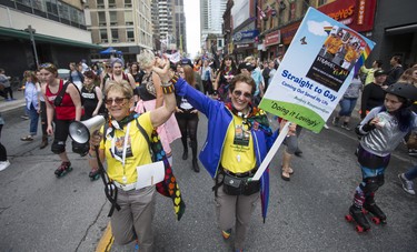 Carol Pasternak (left) and Audrey Kouyoumdjan along Yonge St. in the Dyke March 2018 in downtown Toronto, Ont.  on Saturday June 23, 2018. Ernest Doroszuk/Toronto Sun/Postmedia