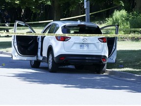 Police investigate at the scene of a double murder on Castlepoint Dr. near Highway 27 and Martin Grove Rd., on Friday June 29, 2018.
