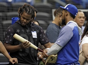 Vladimir Guerrero Jr.’s (left) weight gain is evidently a problem for the Jays, who plan to use him as a third baseman. (AP)