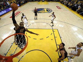 LeBron James of the Cleveland Cavaliers goes up for two of his game-high 51 points but it wasn't enough as the Golden State Warriors posted a 124-114 win in overtime to draw first blood in the NBA Finals Thursday in Oakland.