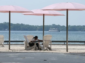 It is cooler down by the lake at Sugar Beach under the trees and umbrellas. Jack Boland/Toronto Sun