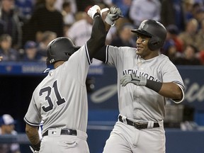 New York Yankees' Miguel Andujar is greeted at home plate by Aaron Hicks after he hit a grand slam against the Toronto Blue Jays at the Rogers Centre on Tuesday, June 5, 2018. (THE CANADIAN PRESS/Fred Thornhill)