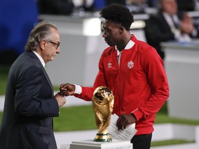 Canadian winger Alphonso Davies (right) is reportedly receiving attention for several of Europe's top clubs. (AP PHOTO)