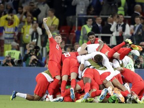 England players celebrate after defeating Colombia at the World Cup on Tuesday. (AP PHOTO)