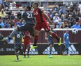 Minnesota United forward Christian Ramirez and Toronto FC defender Nick Hagglund jump for a header during Wednesday's game. (AP PHOTO)