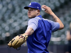 Manny Machado of the Los Angeles Dodgers warms up before the game against the Milwaukee Brewers at Miller Park on July 20, 2018 in Milwaukee, Wisconsin.  (Photo by Dylan Buell/Getty Images)