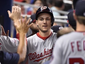 Trea Turner of the Washington Nationals is congratulated by teammates after scoring in the eighth inning against the Miami Marlins at Marlins Park on July 27, 2018 in Miami, Florida. (Eric Espada/Getty Images)