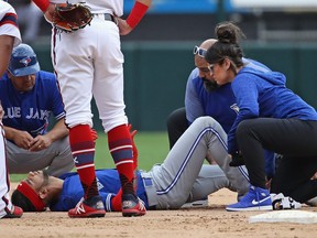 Lourdes Gurriel Jr. #13 of the Toronto Blue Jays is examined by trainers after suffering an apparent leg injuyr in the 9th inning against the Chicago White Sox at Guaranteed Rate Field on July 29, 2018 in Chicago, Illinois. The Blue Jays defeated the White Sox 7-4. (Photo by Jonathan Daniel/Getty Images)