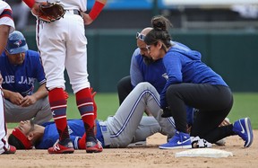 Lourdes Gurriel Jr. #13 of the Toronto Blue Jays is examined by trainers after suffering an apparent leg injuyr in the 9th inning against the Chicago White Sox at Guaranteed Rate Field on July 29, 2018 in Chicago, Illinois. The Blue Jays defeated the White Sox 7-4. (Photo by Jonathan Daniel/Getty Images)