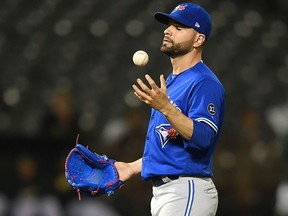 Jaime Garcia #57 of the Toronto Blue Jays reacts with a new ball after giving up a two-run rbi double to Jonathan Lucroy #21 of the Oakland Athletics in the bottom of the eighth inning at Oakland Alameda Coliseum on July 30, 2018 in Oakland, California. The Athletics won the game 10-1.