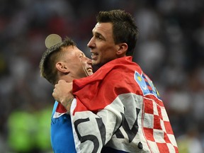 Croatia's Mario Mandzukic (right) celebrates with assistant coach Ivica Olic after beating England on Wednesday. (GETTY IMAGES)
