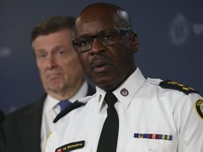 Toronto Police Chief Mark Saunders with Mayor John Tory looking over his shoulder. (Jack Boland, Toronto Sun)