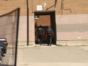 TCHC special constables walk through a complex on Shoreham Court where a  39-year-old man was murdered early Monday. (JACK BOLAND, Toronto Sun)
