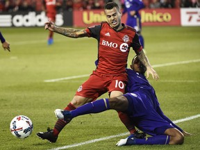 Toronto FC forward Sebastian Giovinco and Orlando City SC defender Tommy Redding battle for the ball during a game earlier this season. (THE CANADIAN PRESS)