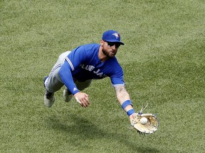 Blue Jays centre fielder Kevin Pillar makes a diving catch on Boston Red Sox's Brock Holt earlier this month. Pillar was injured on the play. (AP PHOTO)