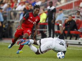 Toronto FC's Ayo Akinola battles for the ball with Ottawa Fury FC's Nana Attakora during Wednesday's game. (THE CANADIAN PRESS)