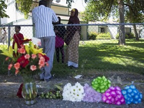 Ibod Hasn, centre, talks to a friend who came to visit after Saturday's stabbing attack in Boise, Idaho, Sunday, July 1, 2018. (Meiying Wu/Idaho Statesman via AP)